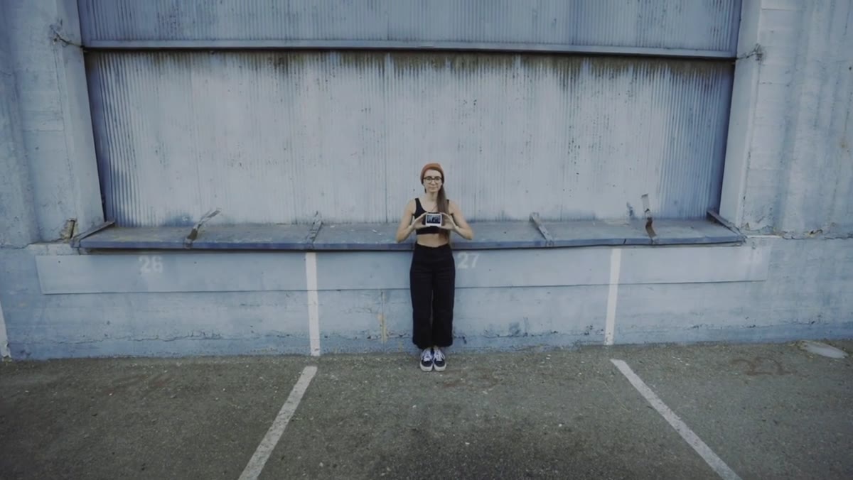 Subject holding instant film photo close to camera lens