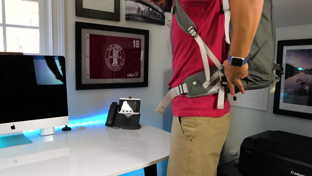 Tripod attached securely to side or front of camera backpack