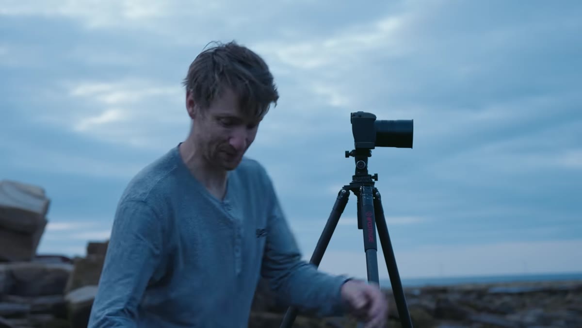Camera on tripod at coastal scene, no filter attached to lens