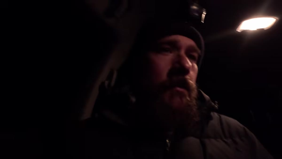 Photographer walking toward a second shooting location in the dark