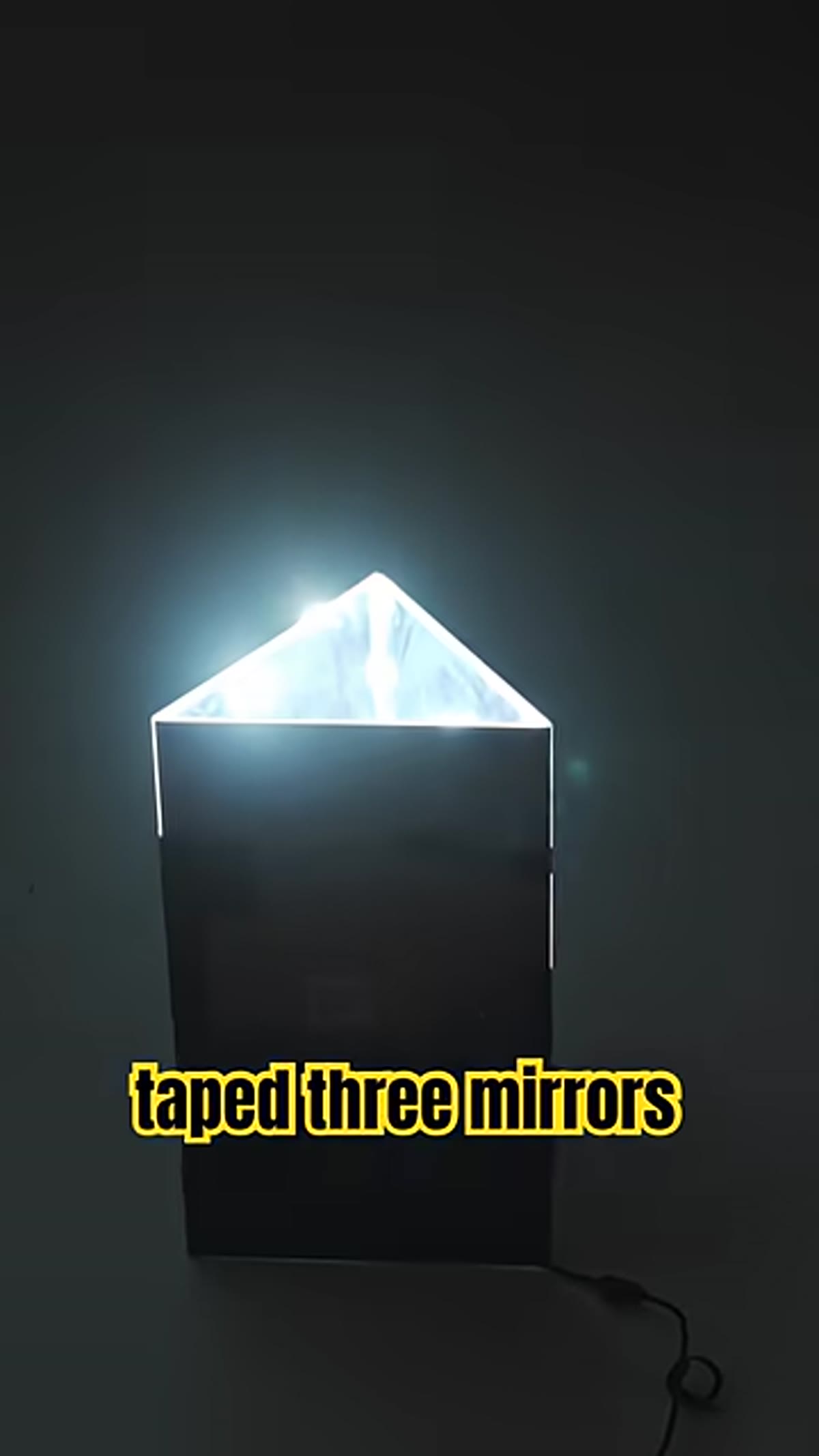 Gaff tape being applied along the edges of two joined mirrors