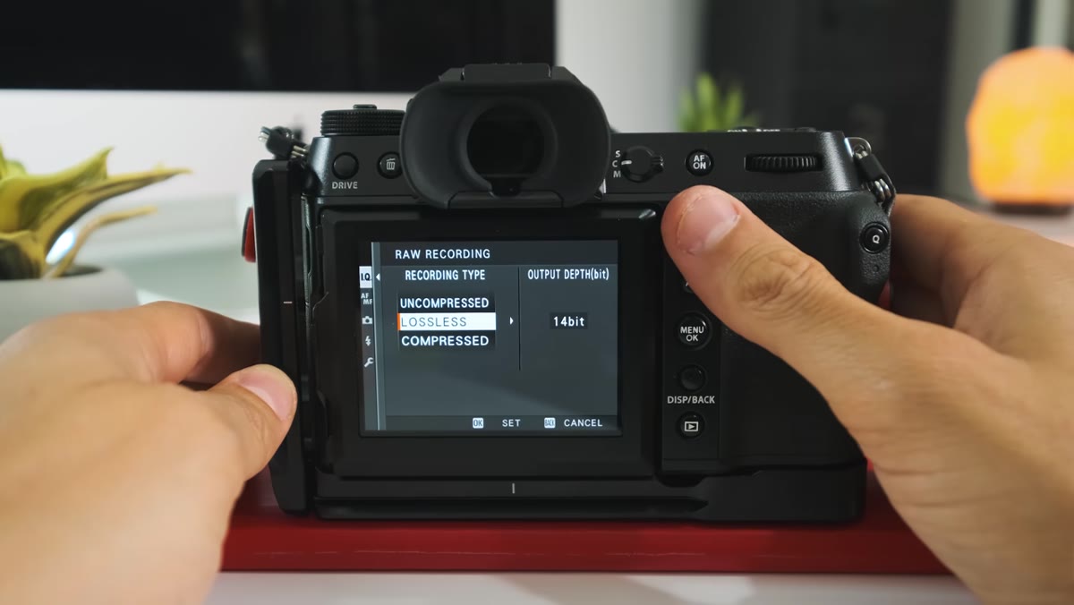 Camera body alongside lenses and accessories laid out