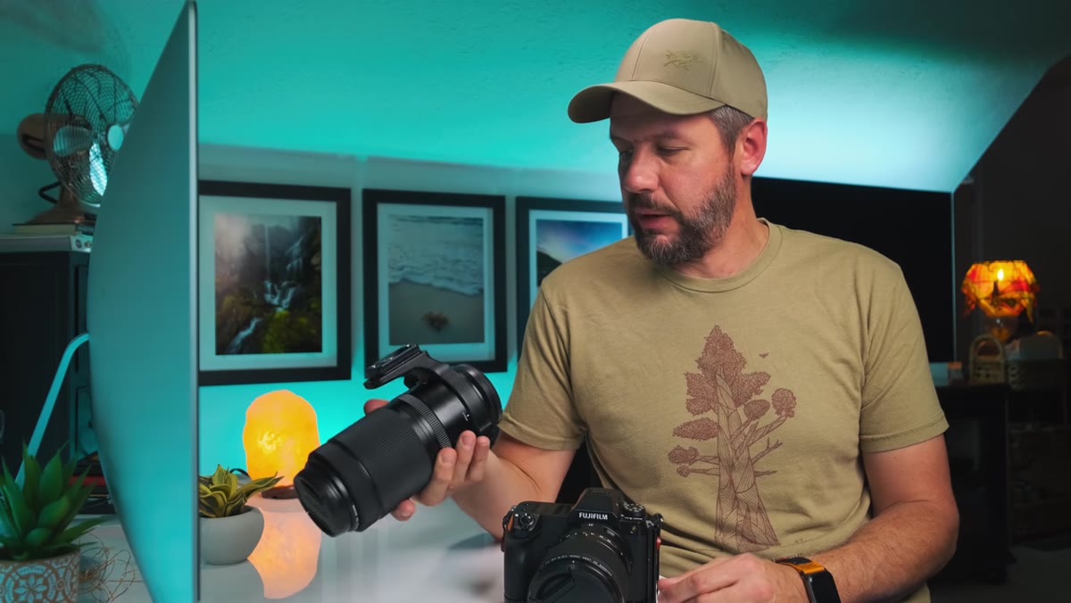 Photographer comparing two camera systems side by side