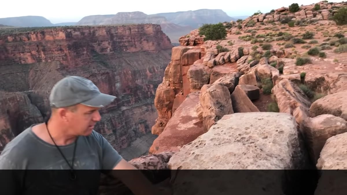 Joel examining sculptural rock formations in foreground