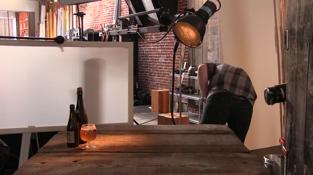 Rob pointing to diffusion panel and reflector setup behind the bottles