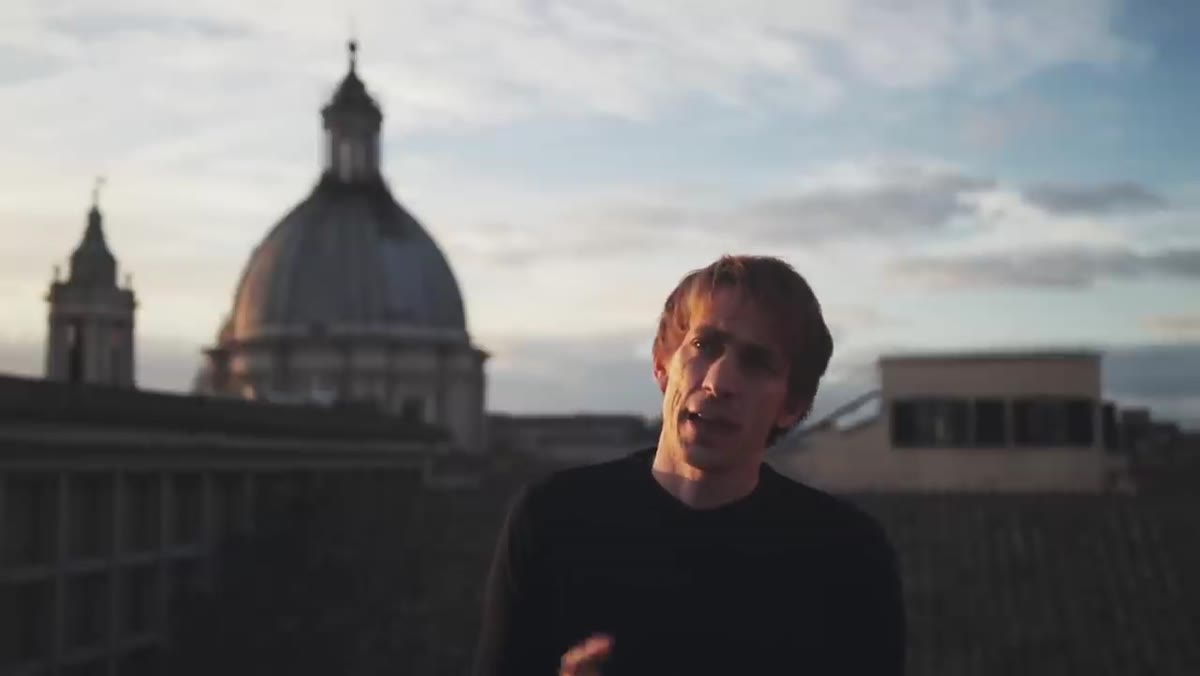 Sean Tucker walking through a Rome street, speaking to camera