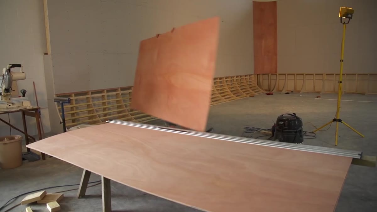 Flexible plywood sheets being applied and screwed to the lattice