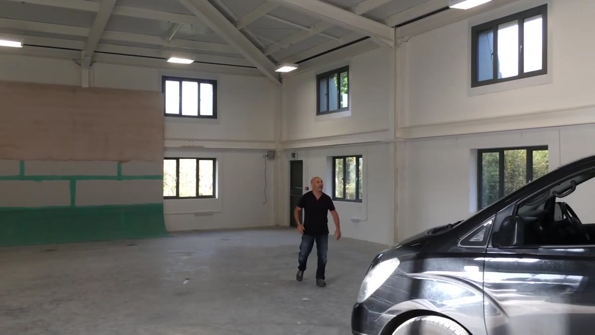Green sealant being applied over the flexible plywood surface