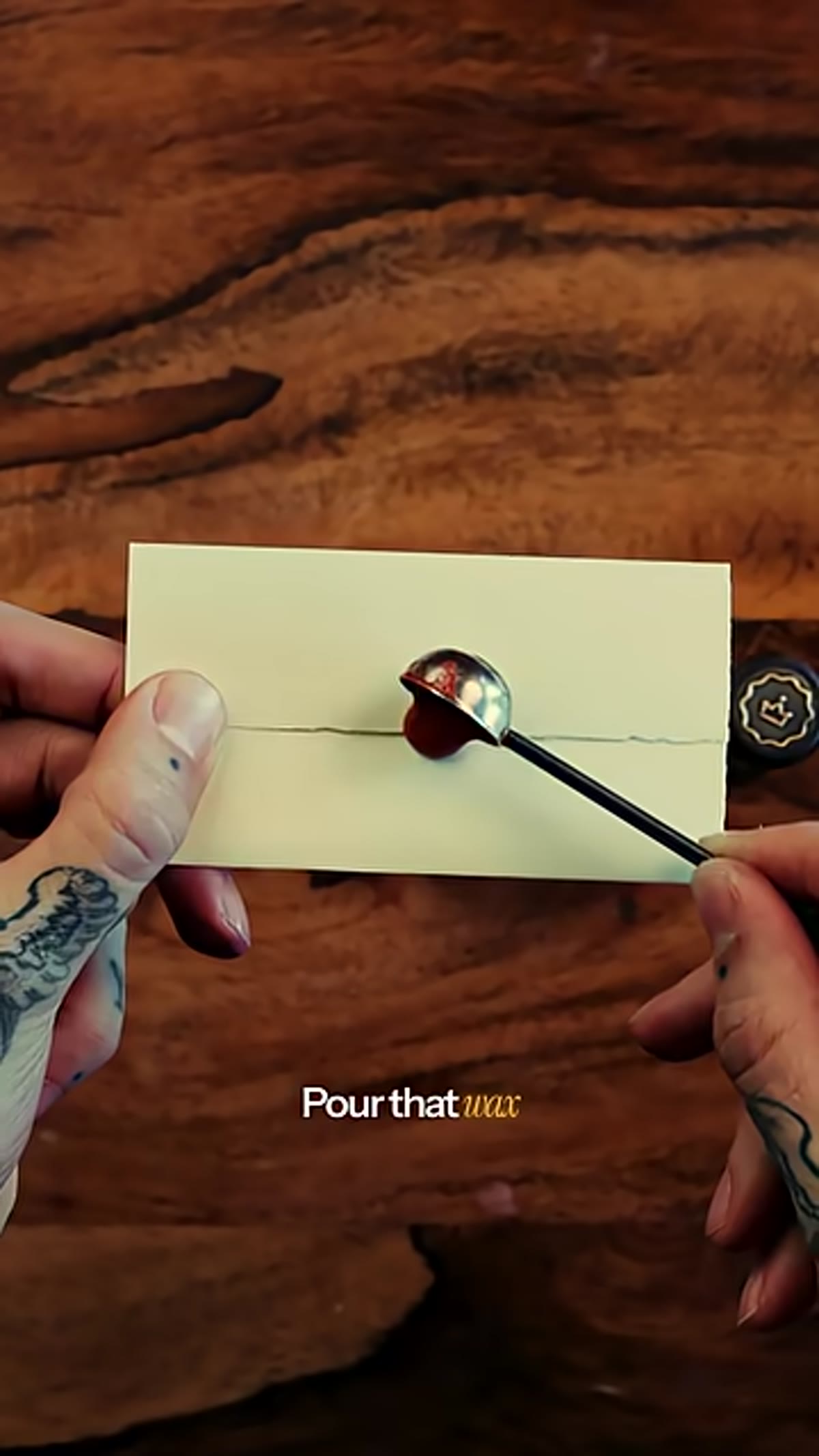 Liquid wax being poured from spoon onto paper