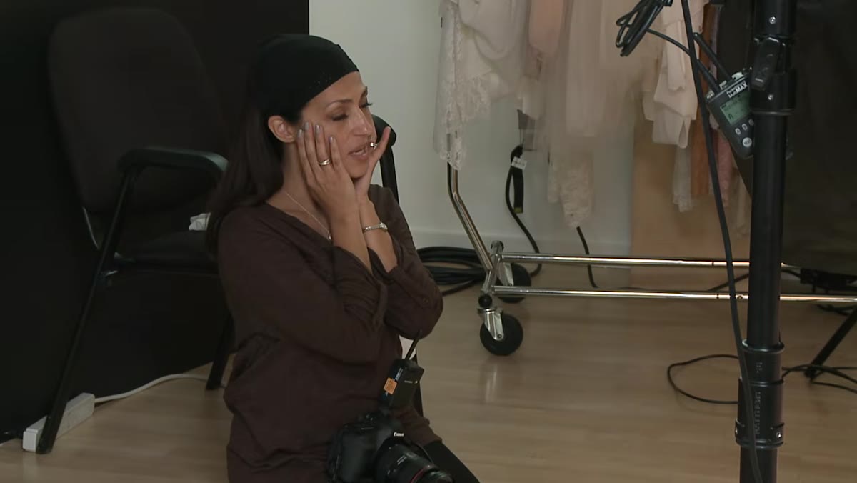 Photographer directing subject through a sequence from upper body down to belly