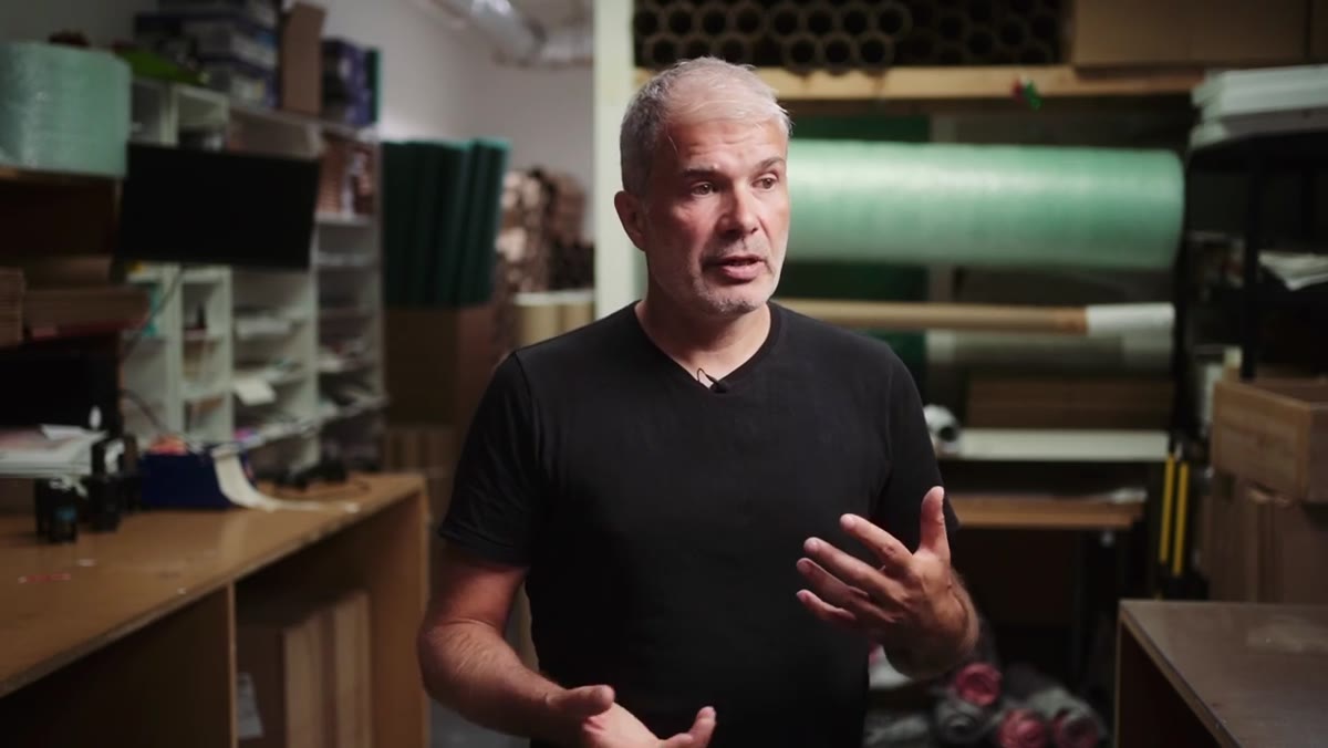 Stuart speaking directly to camera about money and creativity