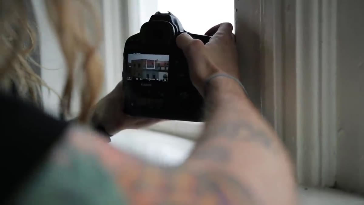 Person filming everyday relational moments over stylized subjects