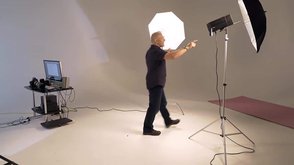 Two silver umbrellas positioned behind the model on each side