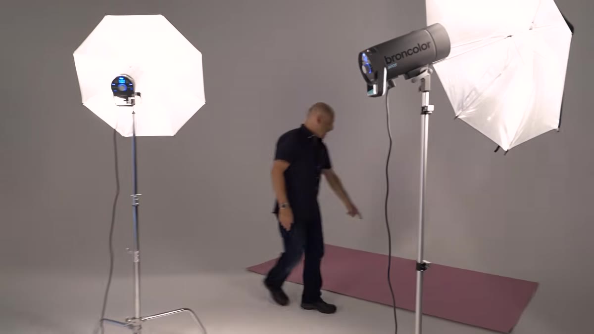 Pink hardboard panel hanging close behind the model near the rear umbrellas