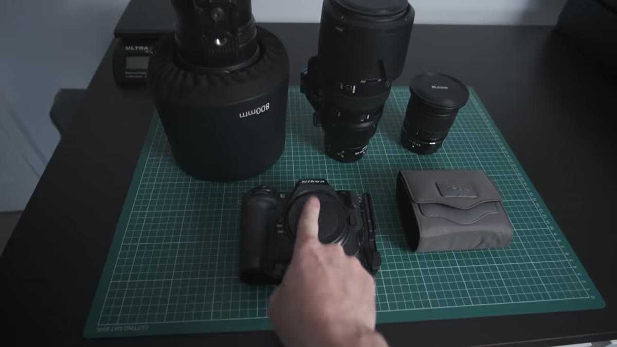 Camera bodies and lenses laid out flat on a surface before packing