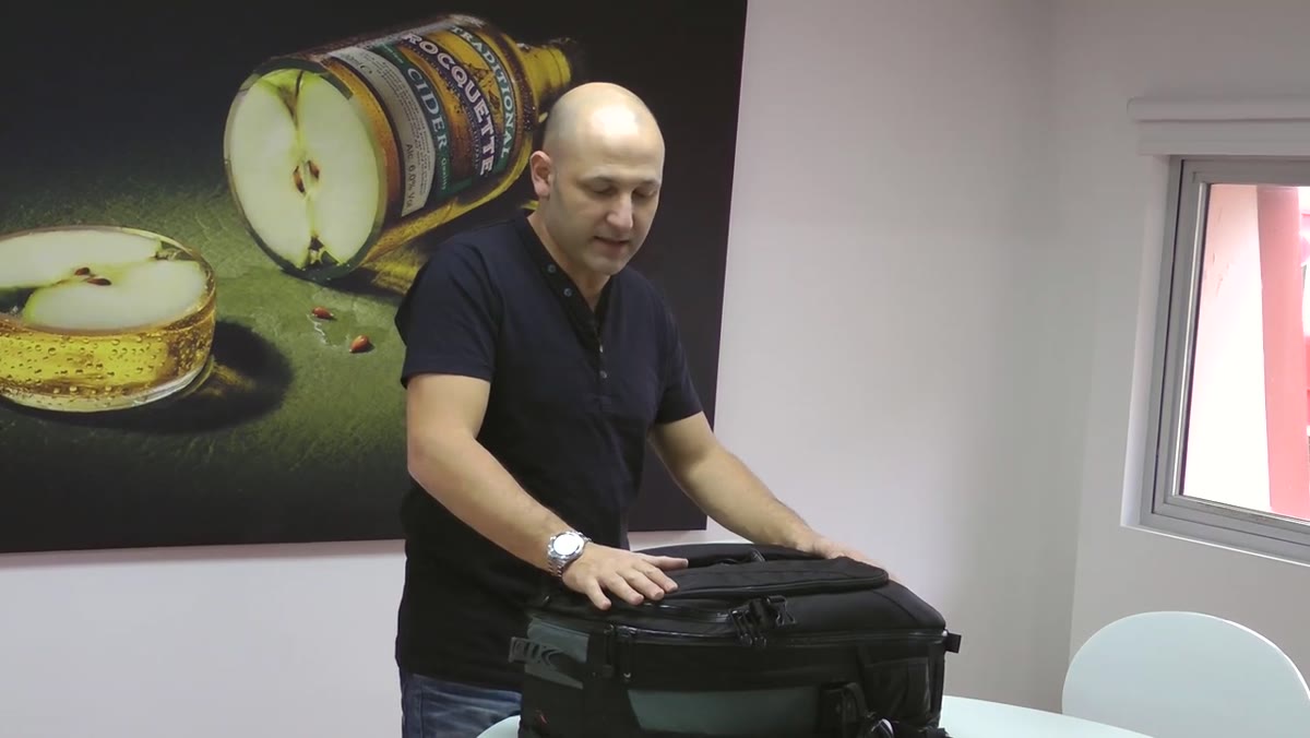 Karl Taylor holding a Lowepro backpack-style camera bag