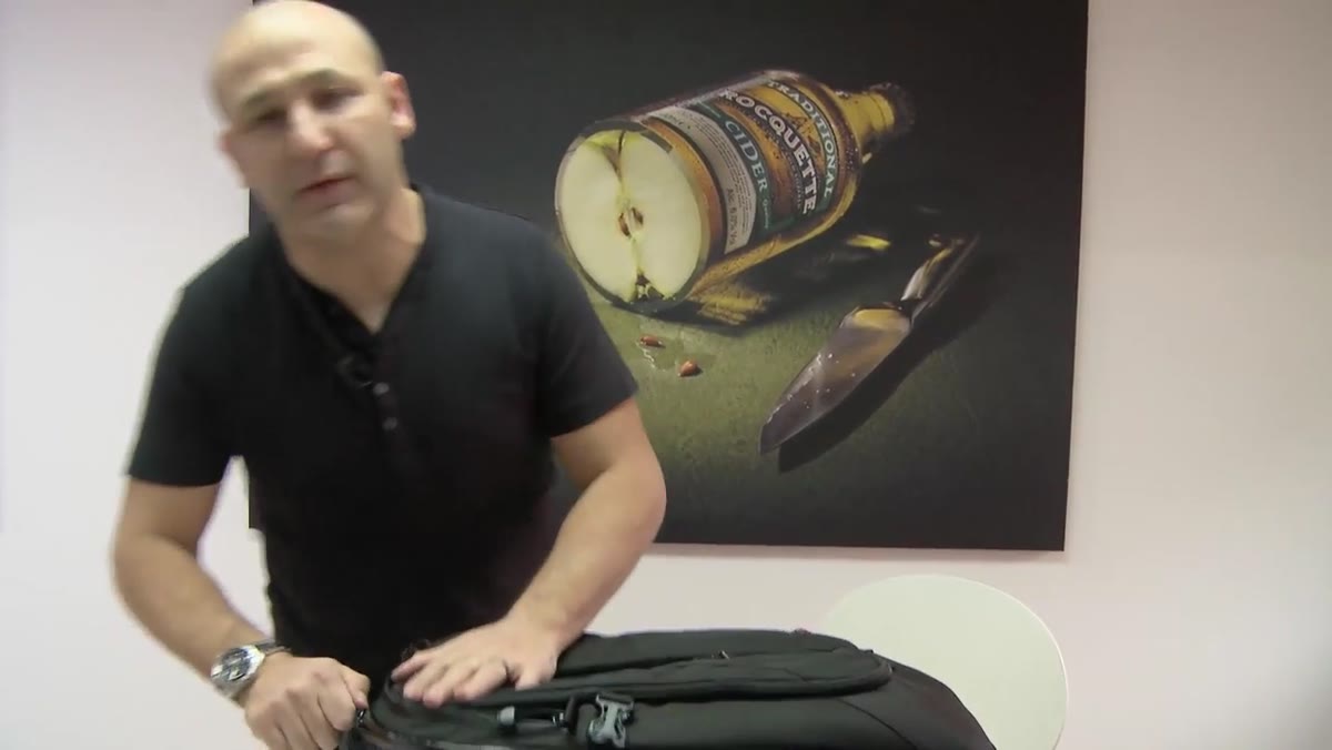 Taylor pointing to the sealed zips on the main compartment