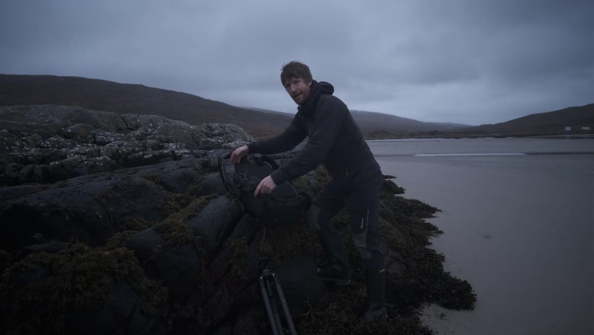 Thomas standing on vast empty tidal flats at low tide