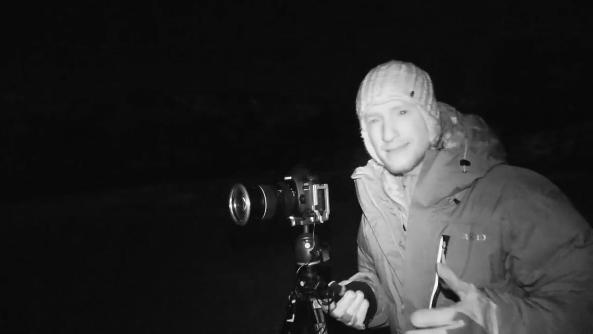 Shutter speed setting on camera display, Northern Lights visible in sky