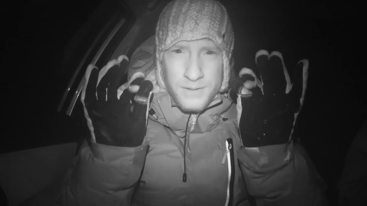 Photographer returning to car after lights fade over mountain pass