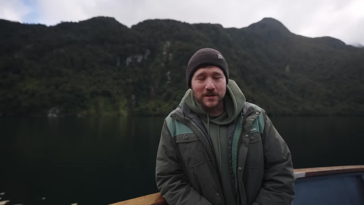 Misty fjord layers visible from the boat deck