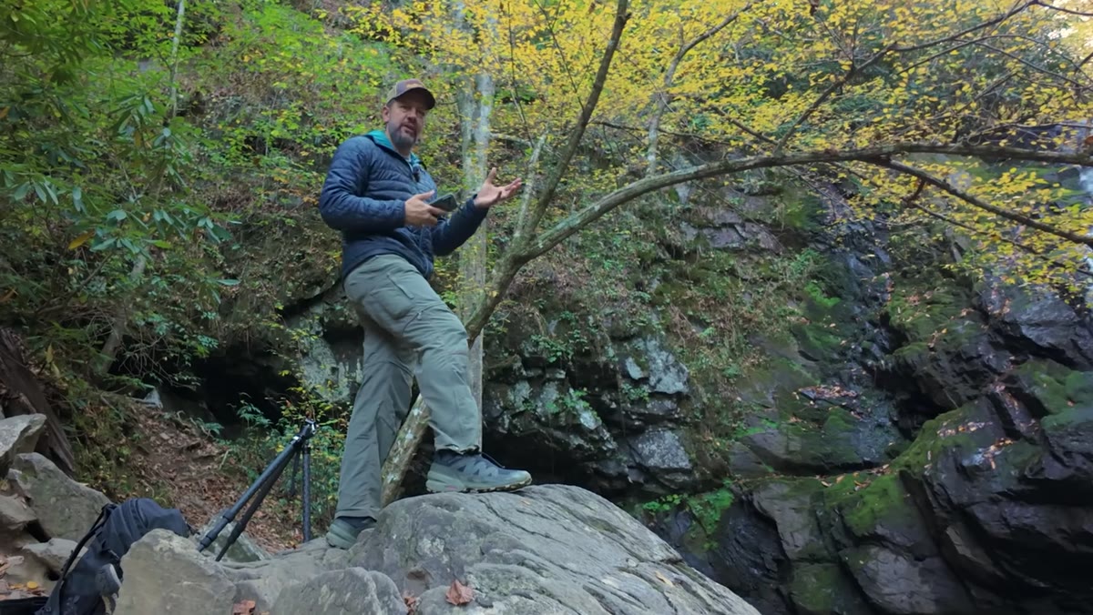Mark gesturing toward natural curves and shapes in the landscape