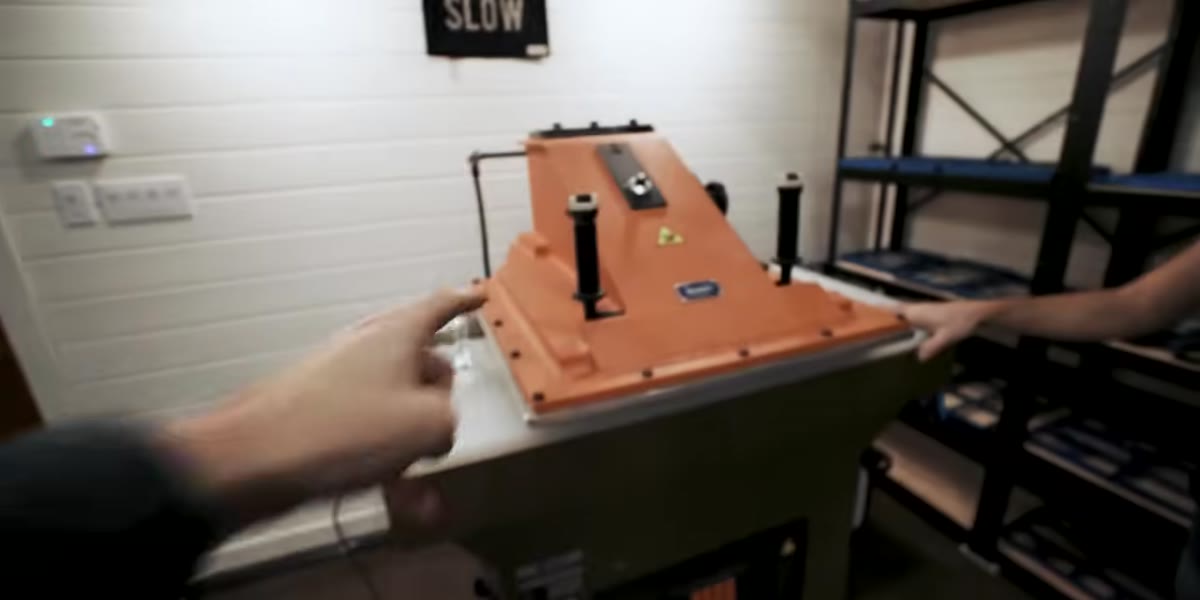 Hands placing a leather die into the clicker press