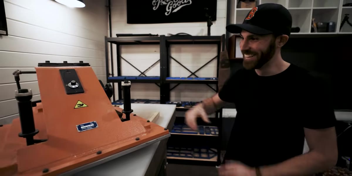 The clicker press compressing leather with a mechanical sound