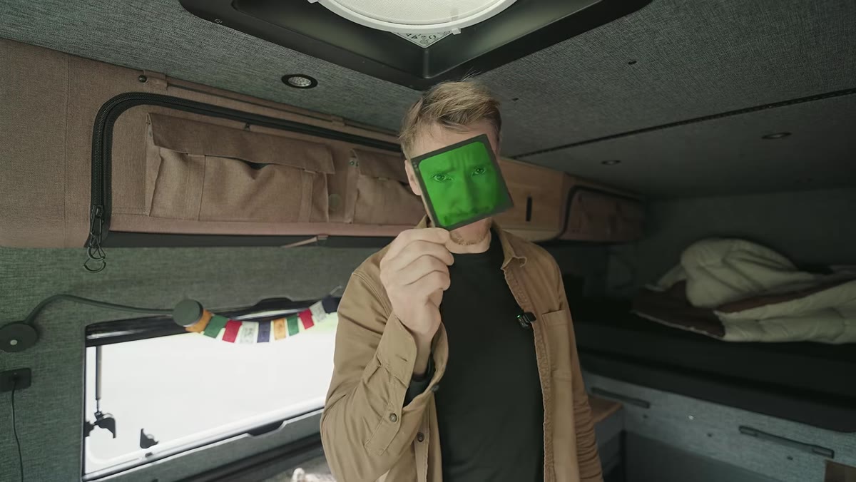Green filter being held up in front of camera lens