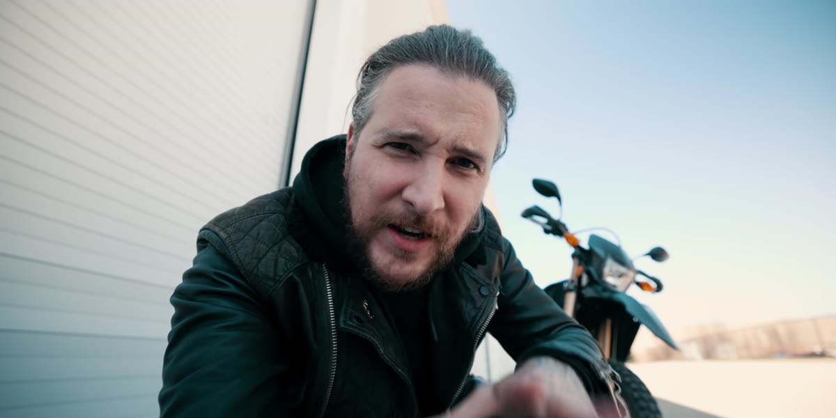 Peter introduces lifestyle photography concept beside a motorcycle