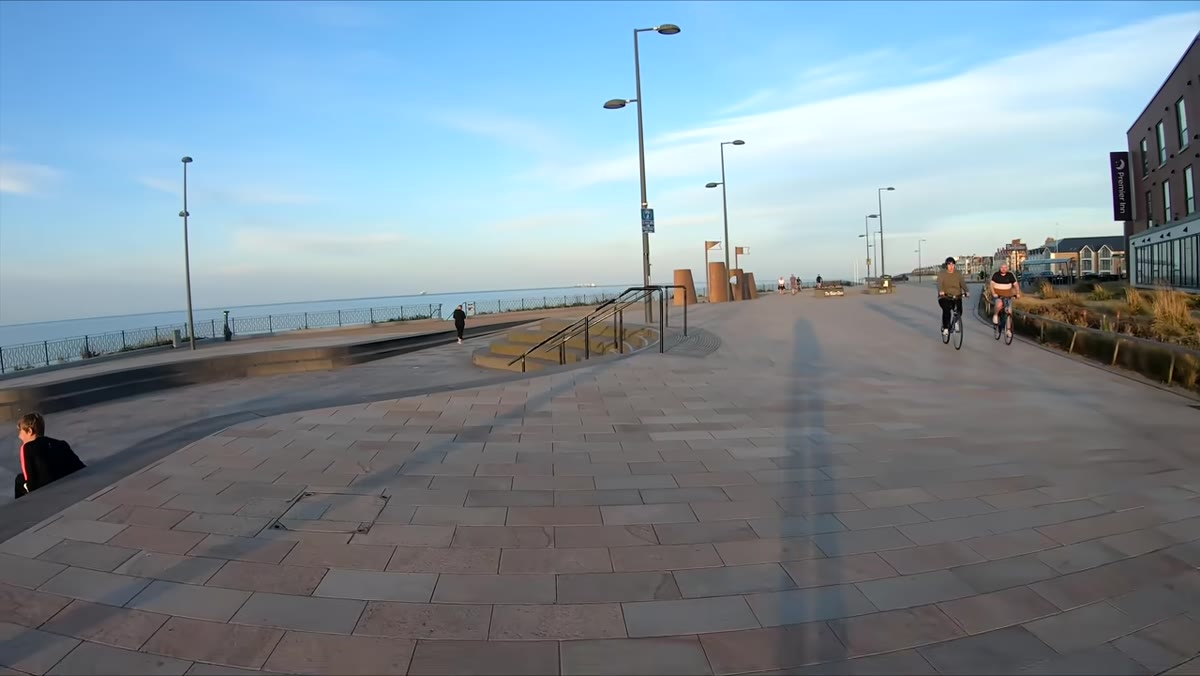 Thomas walking along a busy English beach with the Hasselblad