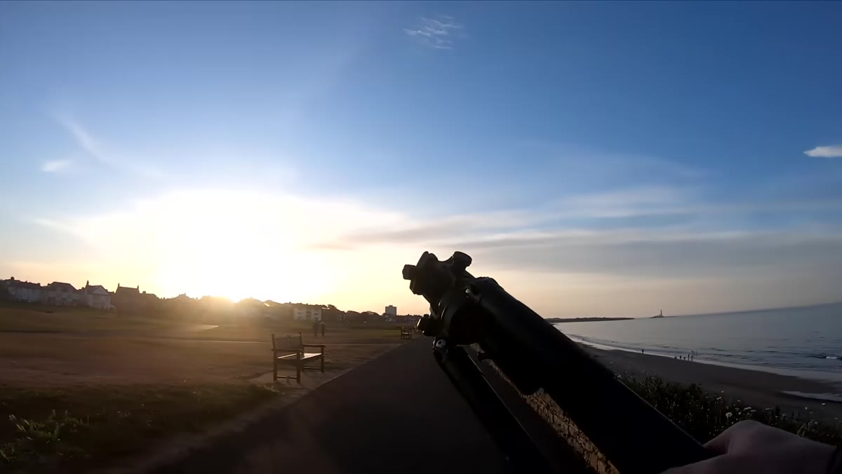 Wide view of the coast showing the eastern sky with pink sunset hues