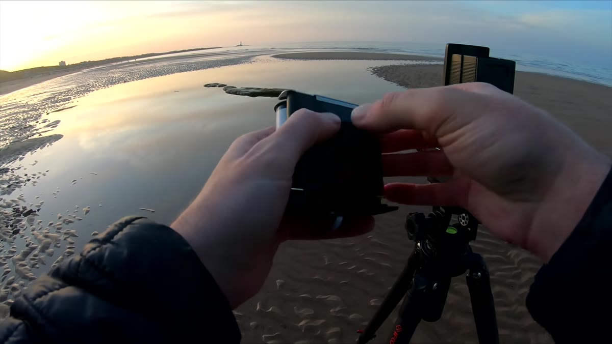 Hasselblad film back being loaded on the beach in a hurry