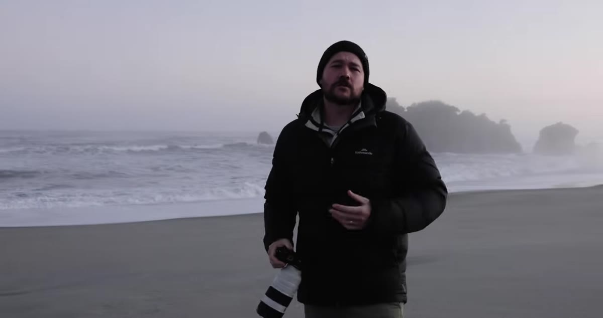 Wide shot of beach shoreline with gentle incoming waves