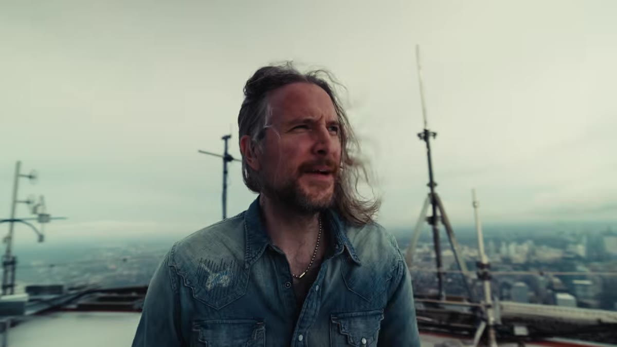 McKinnon strapped to the CN Tower edge, evaluating the angle