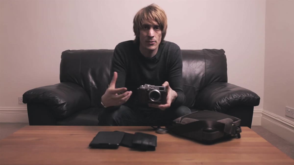Tucker holding the Fuji X100 up toward the camera