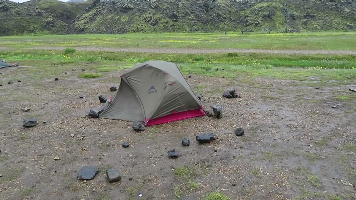 Group packing up camp as storm clouds close in on the Highlands