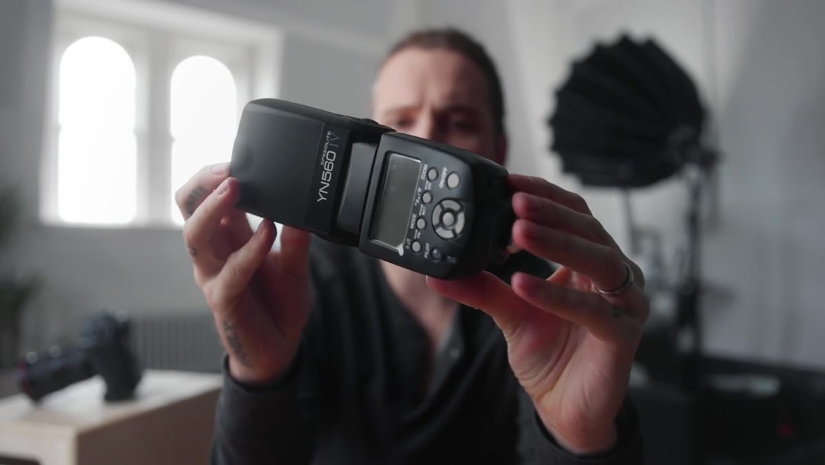 Yongnuo YN560 flash unboxed showing included soft case and unit