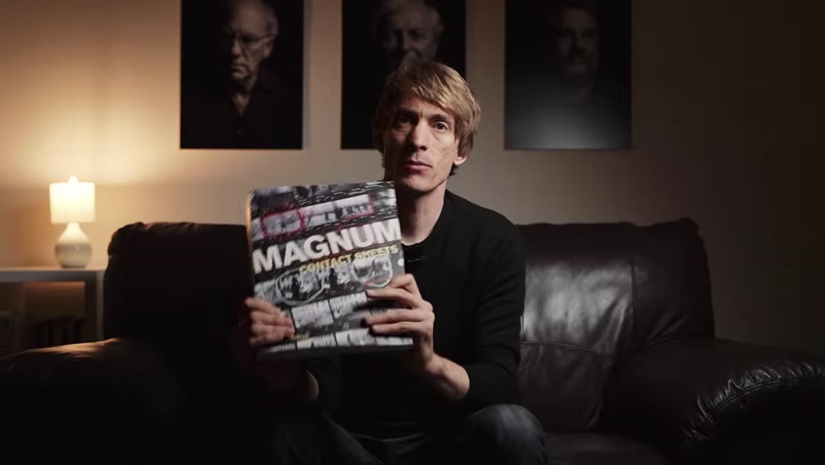 Tucker holding the Magnum Contact Sheets book open to Cartier-Bresson&rsquo;s Seville sequence