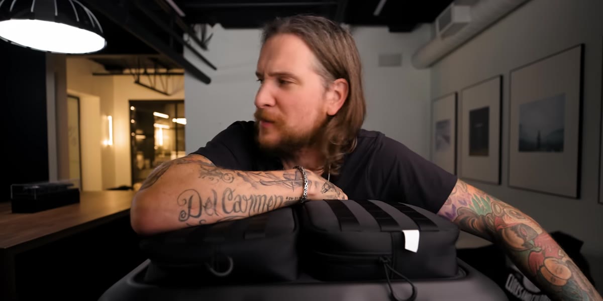 Peter holding the Ronin 4D body, pointing to the gimbal arm