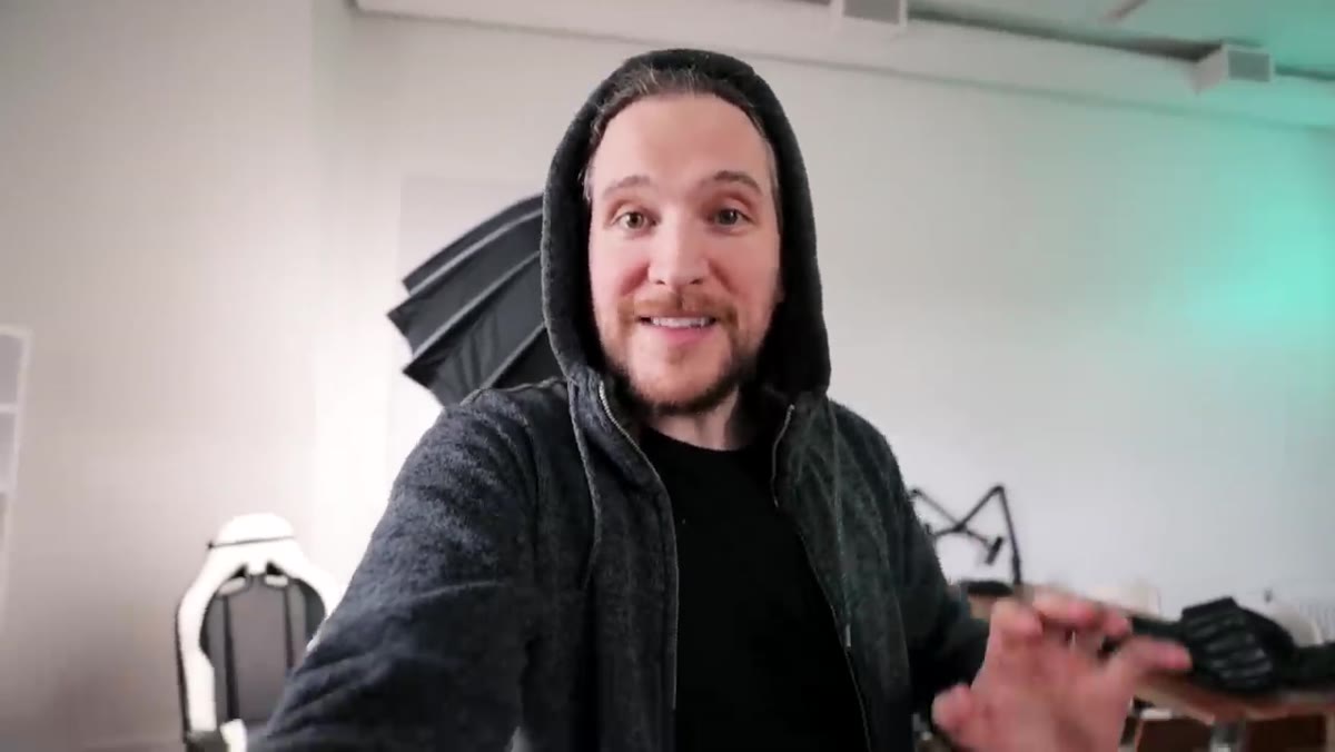 Peter gesturing naturally with both hands, camera floating beside him
