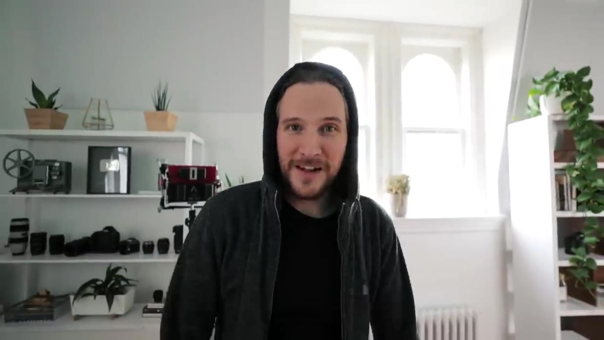 Peter casually reclaiming camera mid-movement with no visible break in footage