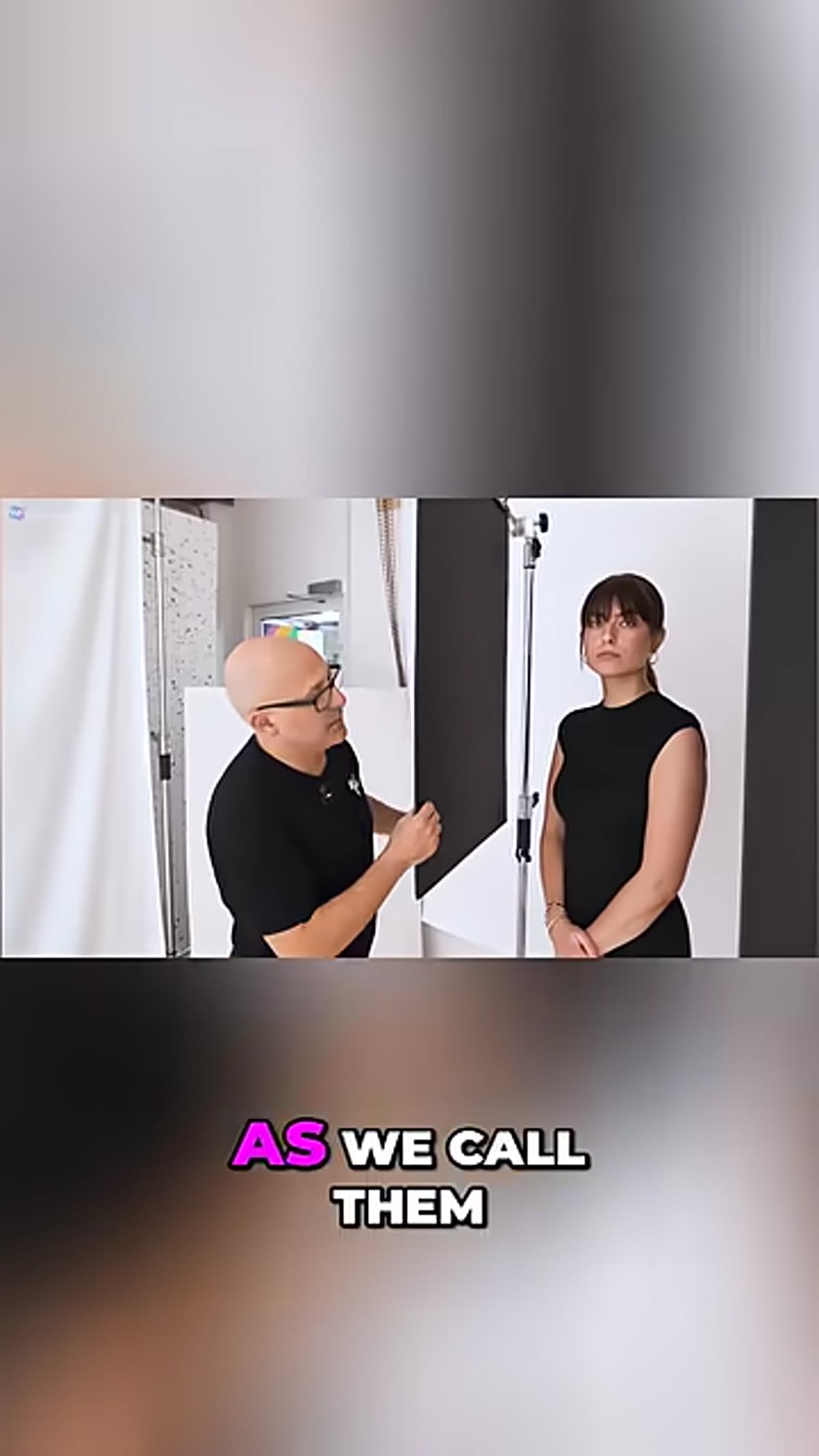 Photographer holding black foam board next to subject&rsquo;s face