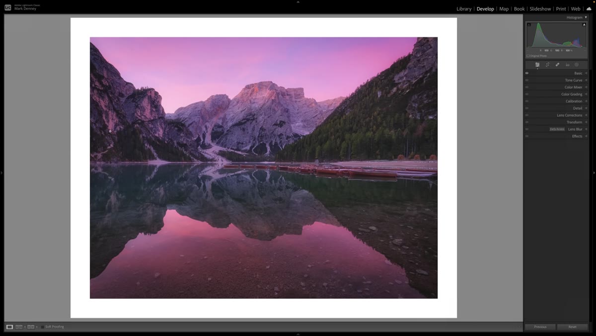 Photographer composing wide shot before sunrise in darkness
