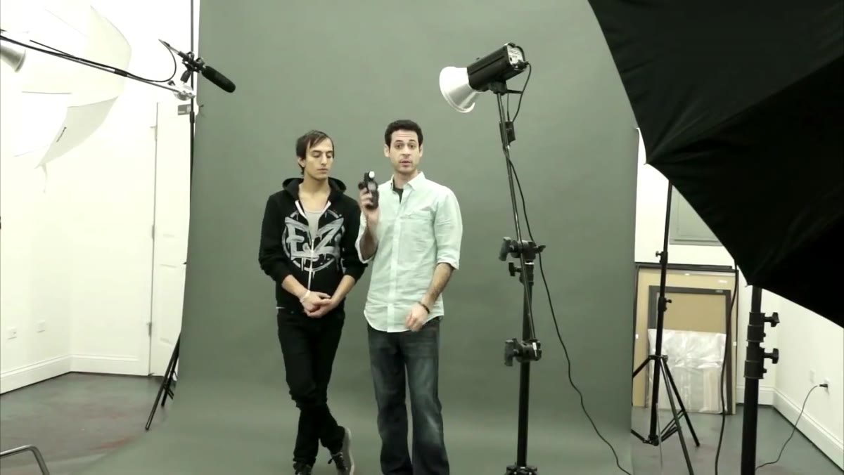 Light meter being held near subject&rsquo;s face, reading displayed on screen