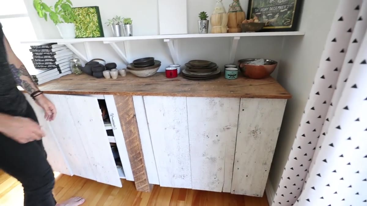 Dennis showing tarnished, worn utensils and props from his collection