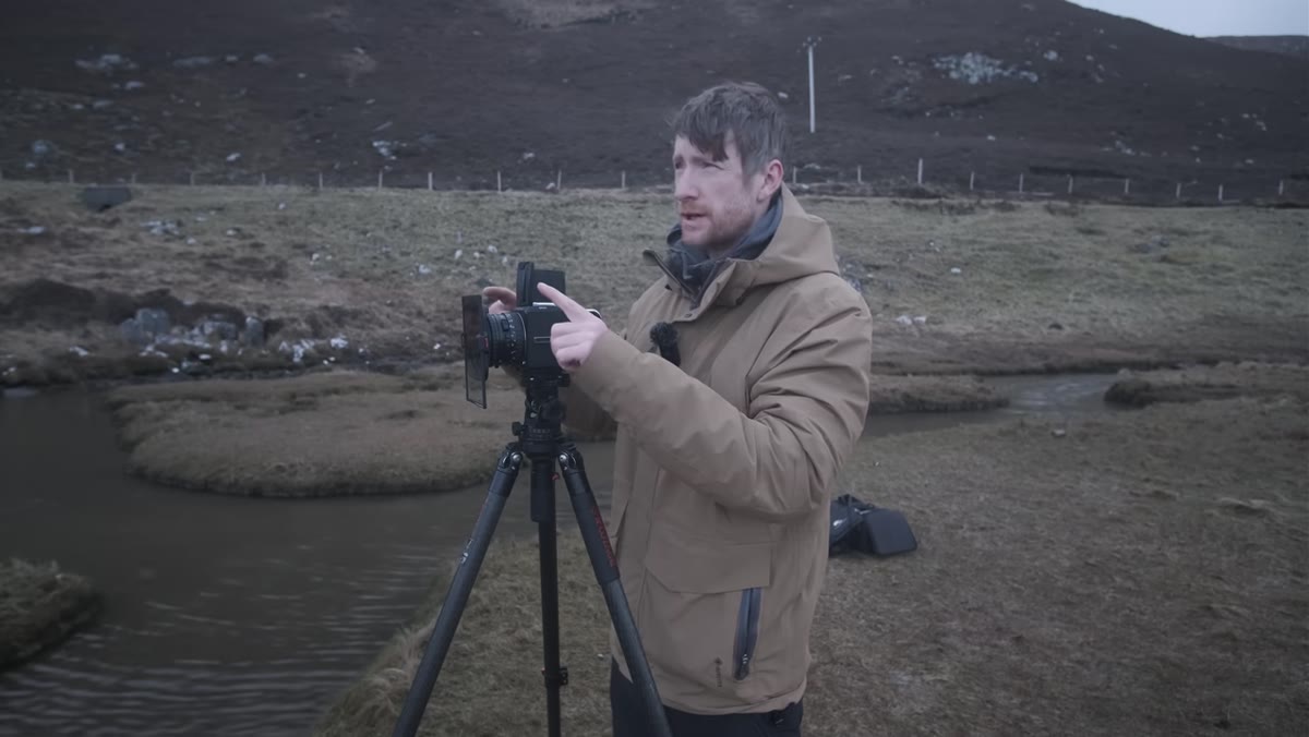 Two-stop soft edge grad filter being placed over Hasselblad lens