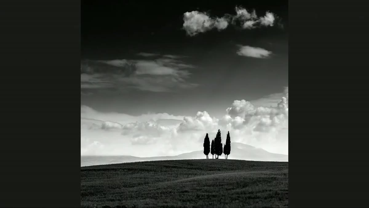 Wide landscape images of rolling Tuscan hills with soft clouds