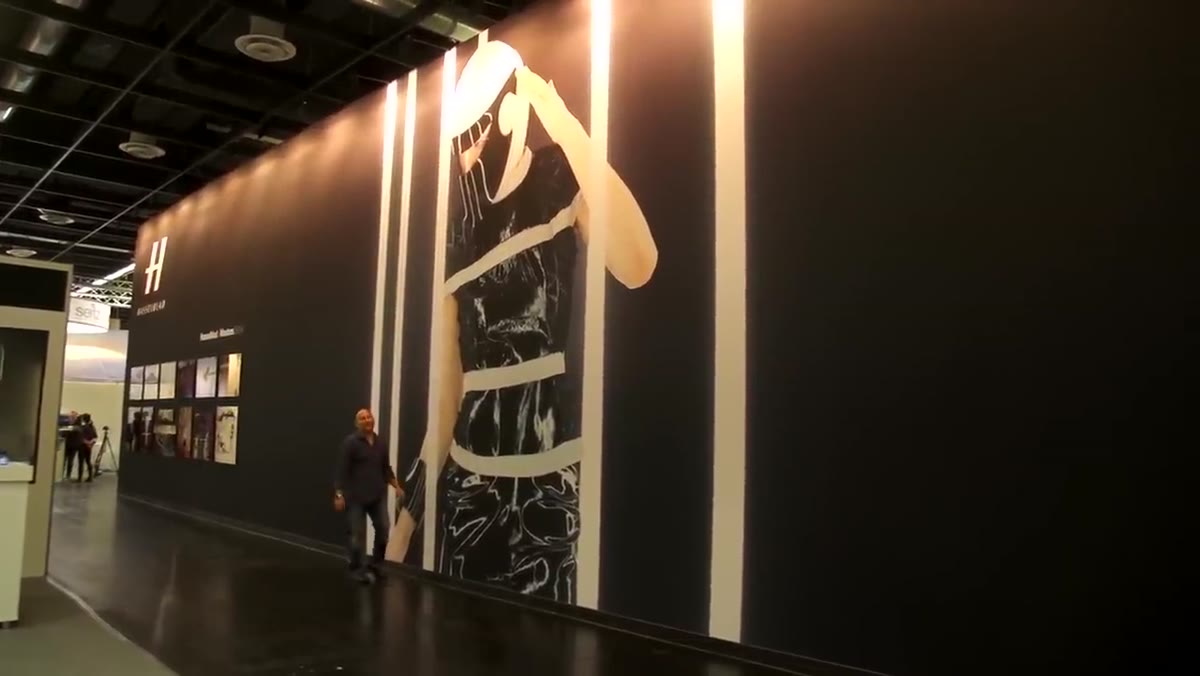 Wide shot of towering exhibition print on Hasselblad stand