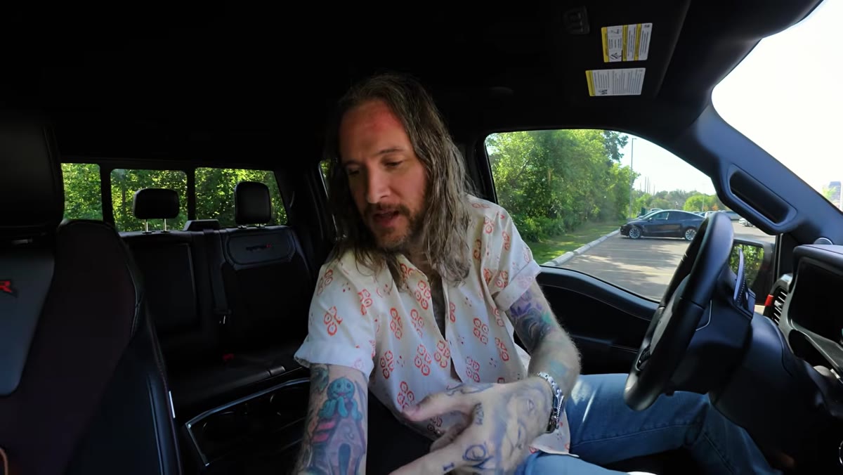 Peter in cab, holding camera up and speaking into it